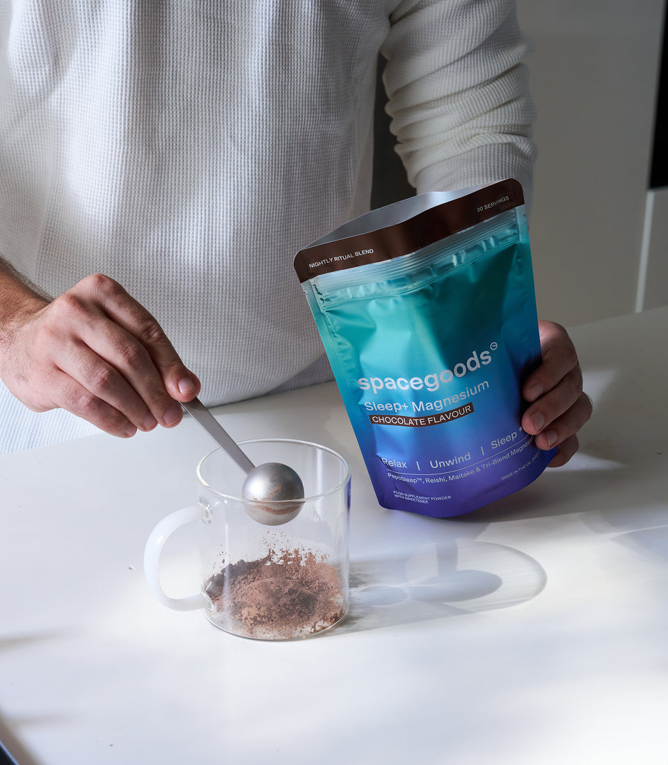 Add a scoop of Sleep+ Chocolate powder to a glass mug.